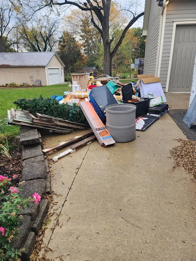Dumpster being loaded with debris for 12 Yard Dumpster Rental in Pomona